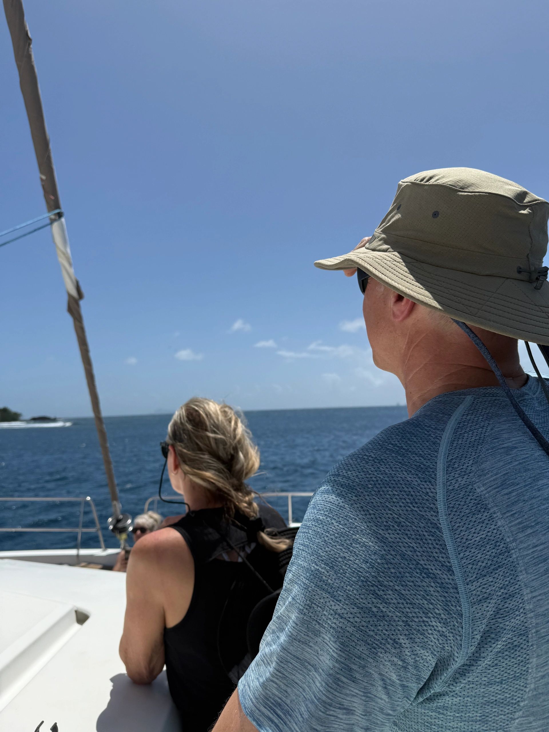 Guests relaxing together on the deck of a sailing catamaran